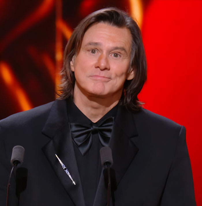 Jim Carrey in a black suit speaking at an event with a focus on his face after controversy with Dr Terry Dubrow's verdict. Jim Carrey in a black suit speaking at an event with a focus on his face after controversy with Dr Terry Dubrow's verdict.