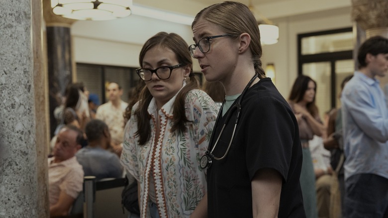 Mel leading Becca through the ER waiting room on The Pitt