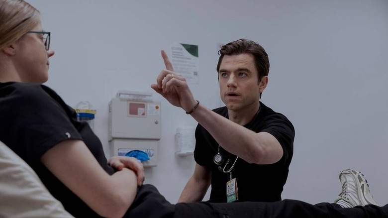 Langdon performing a sight exam on Mel on The Pitt