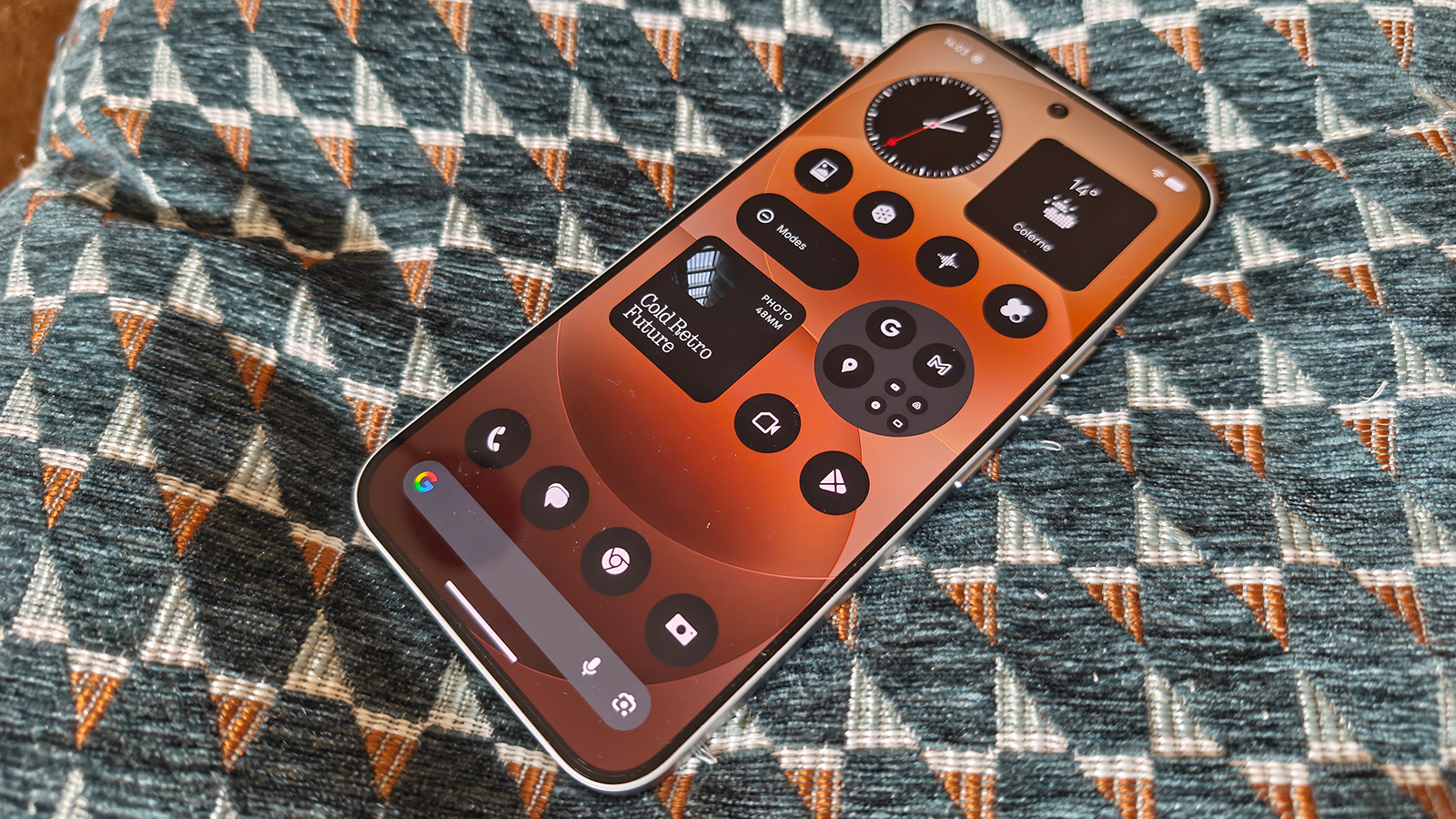 Photos of a silver phone on a cushion