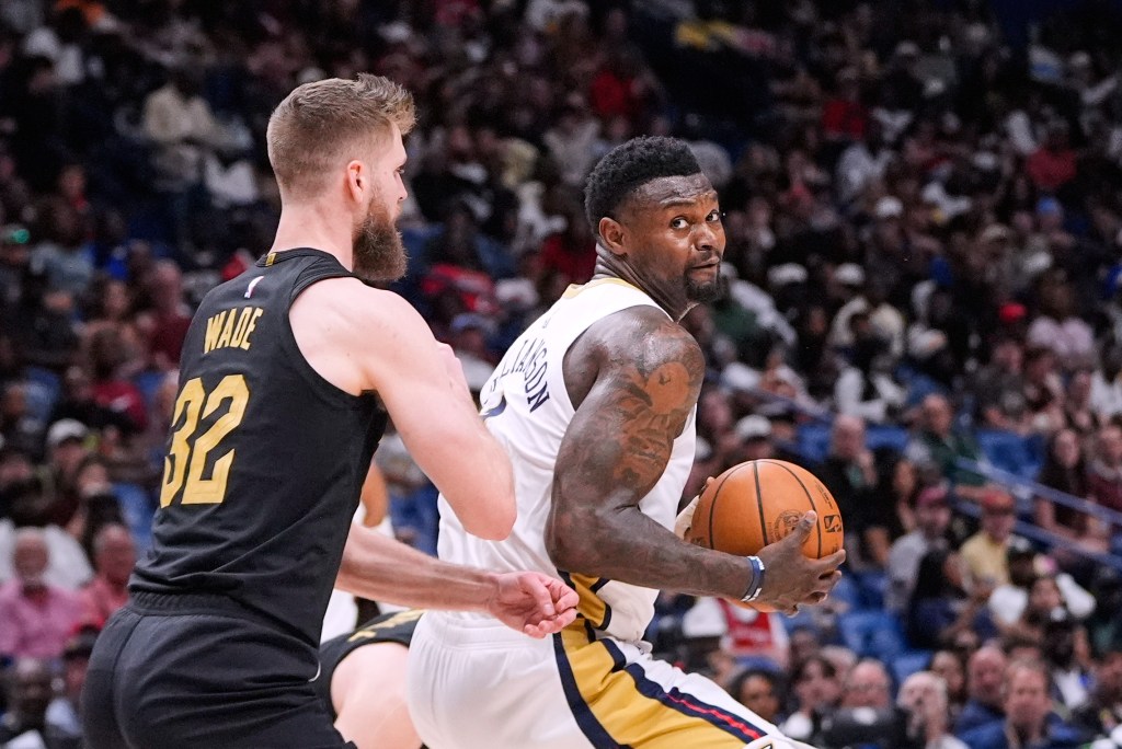 Zion Williamson looks to go to the basket against Cleveland Cavaliers forward Dean Wade (32) in the second half of an NBA basketball game, Saturday, March 21, 2026, in New Orleans.