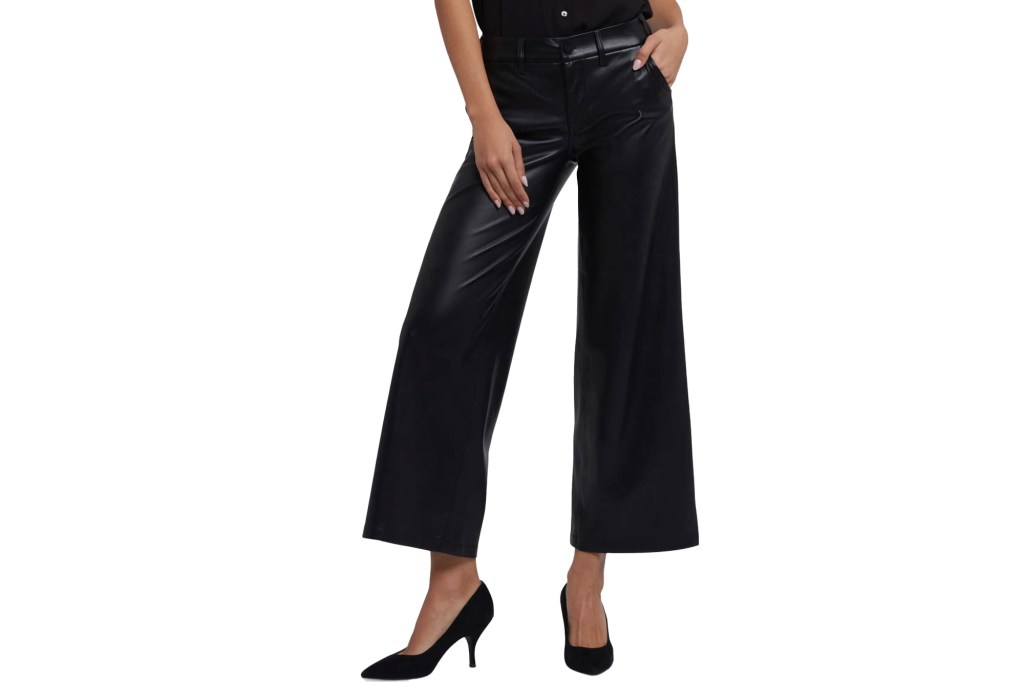 Woman wearing black pleather wide-leg pants and black heels.