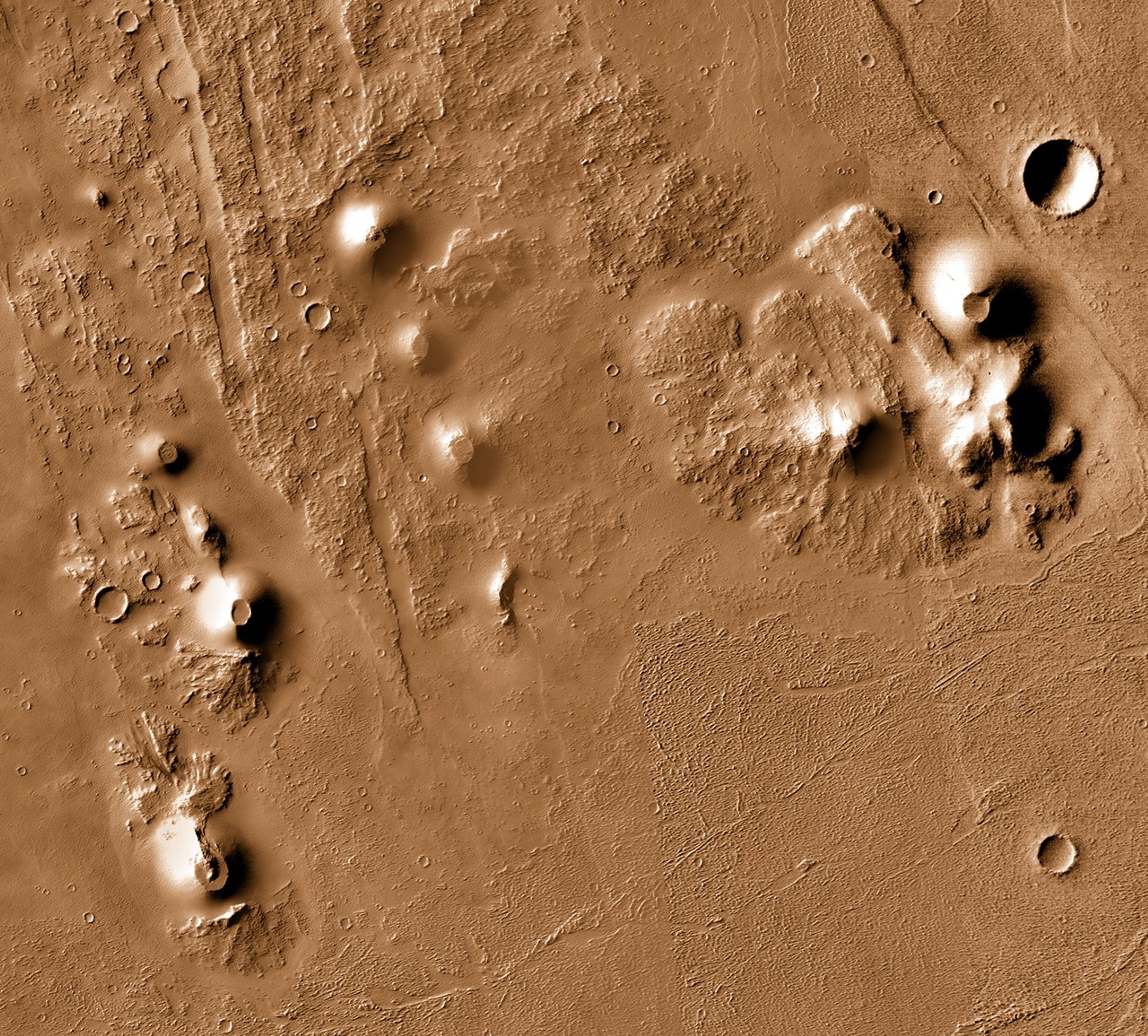 A downward-looking satellite image shows several scoria cones in the Ulysses Colles volcanic field on Mars. The cones look like small hills against a textured background of lava flows, circular impact craters, and linear features called grabens. The landscape is reddish.