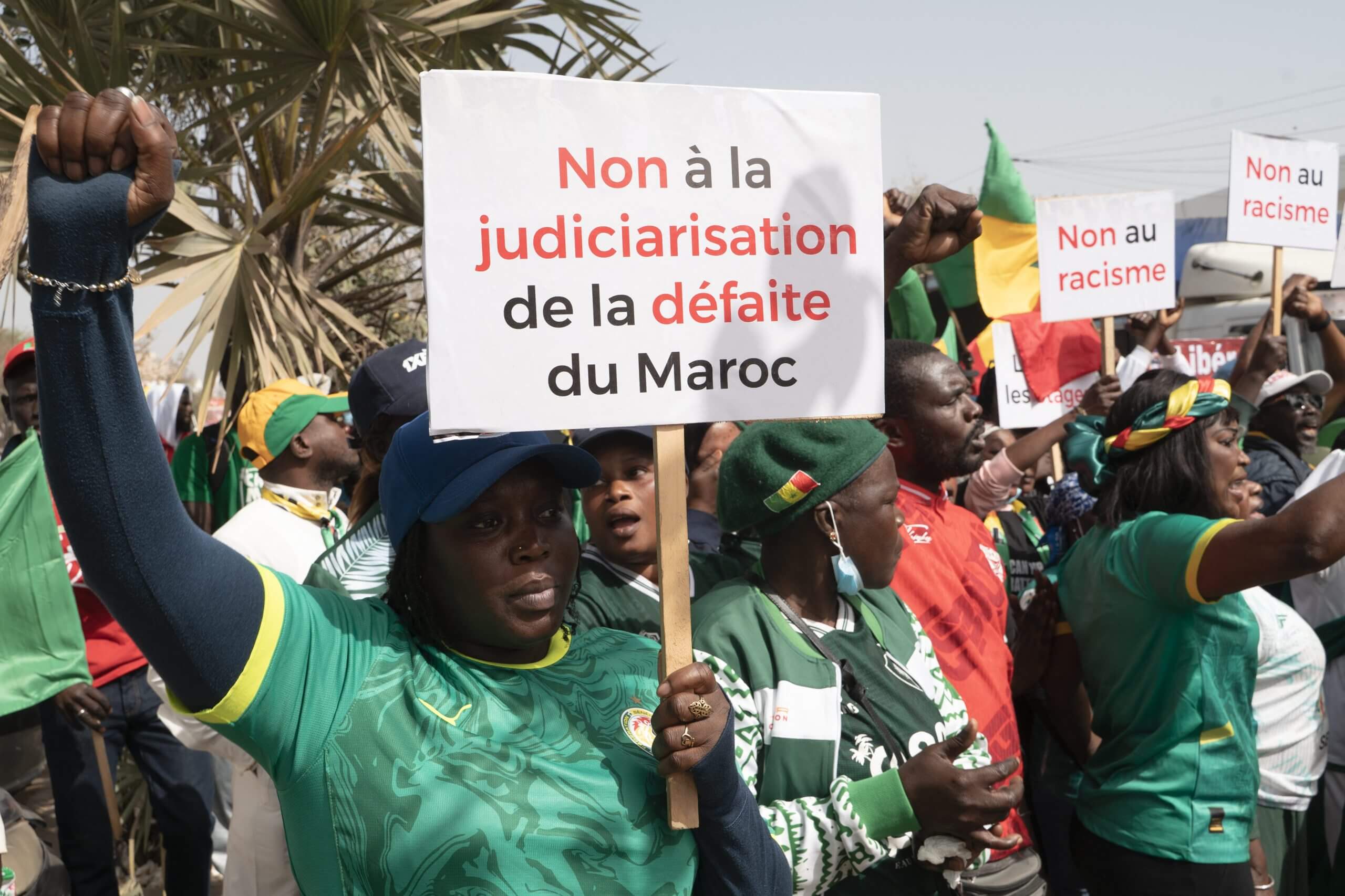 A Senegalese protestor holds a sign