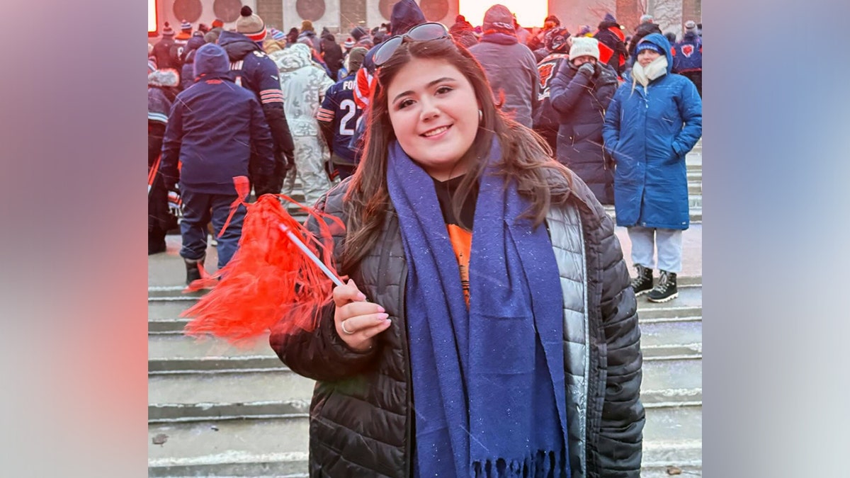 Loyola student Sheridan Gorman stands with a pompom in hand.