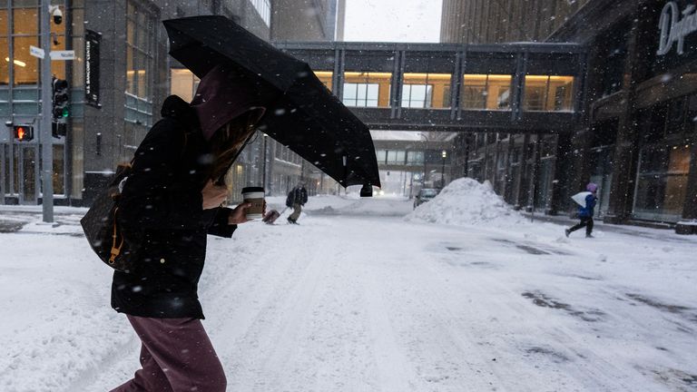 A woman walks during a snowstorm in Minneapolis, Minnesota. Pic: AP/Minnesota Star Tribune