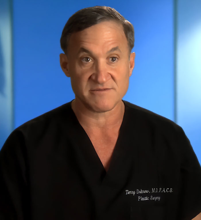 Dr. Terry Dubrow from Botched in black scrubs giving medical verdict on Jim Carrey’s face controversy in a studio setting Dr. Terry Dubrow from Botched in black scrubs giving medical verdict on Jim Carrey’s face controversy in a studio setting