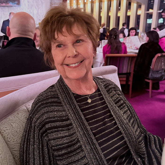 Older woman smiling in a crowded restaurant setting, highlighting behind-the-scenes toxic drama amid Today Show return. Older woman smiling in a crowded restaurant setting, highlighting behind-the-scenes toxic drama amid Today Show return.