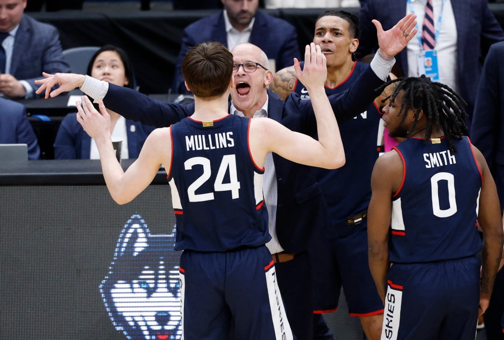 UConn Huskies head coach Dan Hurley congratulates guard Braylon Mullins after he made the game-winning three-point basket.