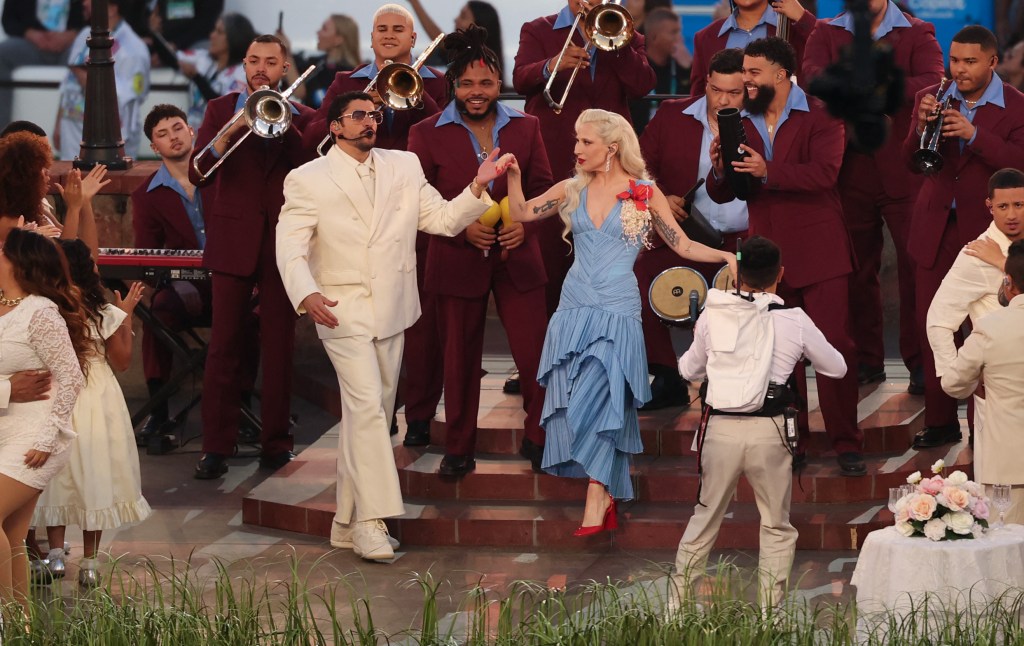 Lady Gaga and Bad Bunny performing at the Super Bowl halftime show with a brass band.