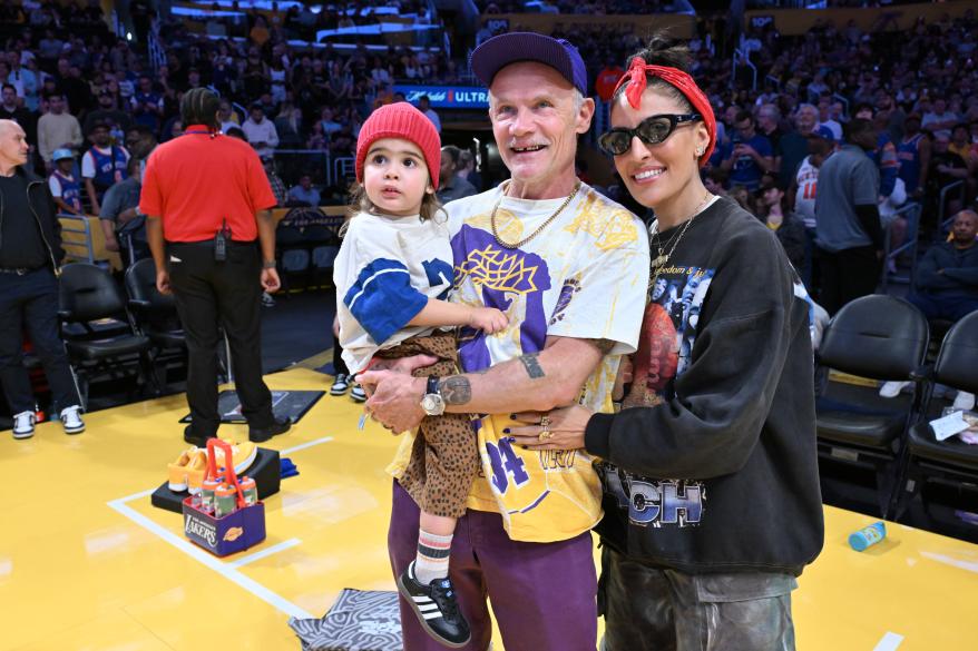 Flea, Melody Ehsani, and their son Darius Booker Balzary attend a Lakers basketball game.
