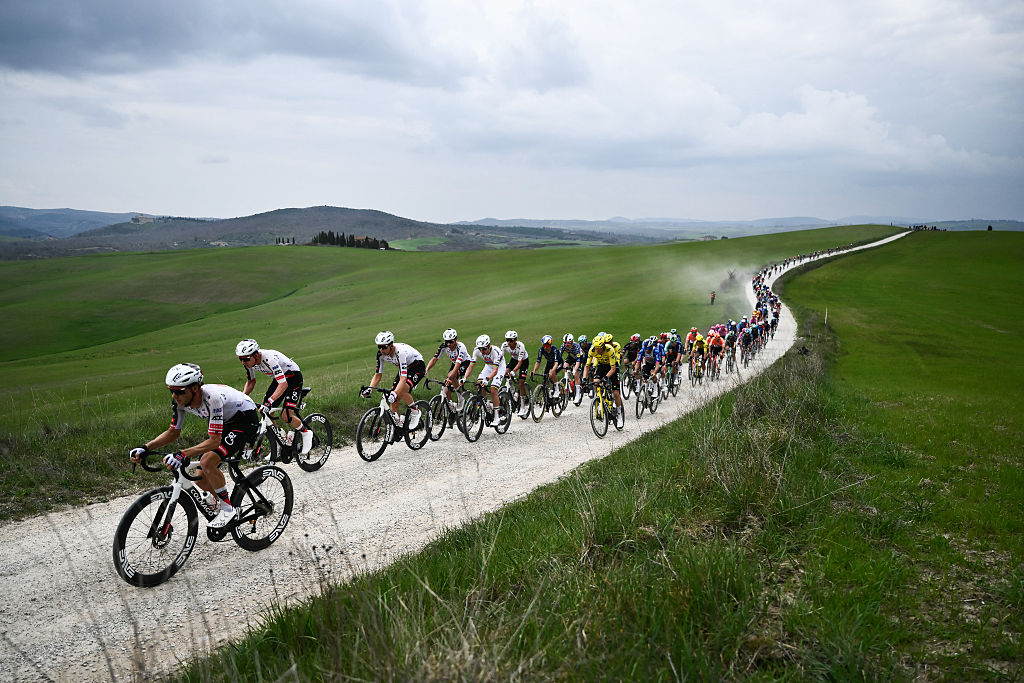 The pack rides during the 20th one-day classic 'Strade Bianche' (White Roads) men's cycling race between Siena and Siena in Tuscany on March 7, 2026. (Photo by Marco BERTORELLO / AFP)