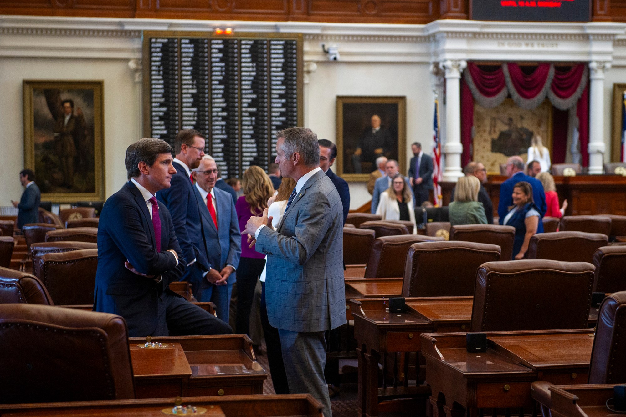 State Rep. Brooks Landgraf, R-Odessa, speaks with Rep. Tom Oliverson, R-Cypress, on the House floor in Austin on July 24, 2025.