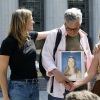 People hold a photo of a loved one outside of the Los Angeles Superior Court on March 25, 2026 in Los Angeles, California.
