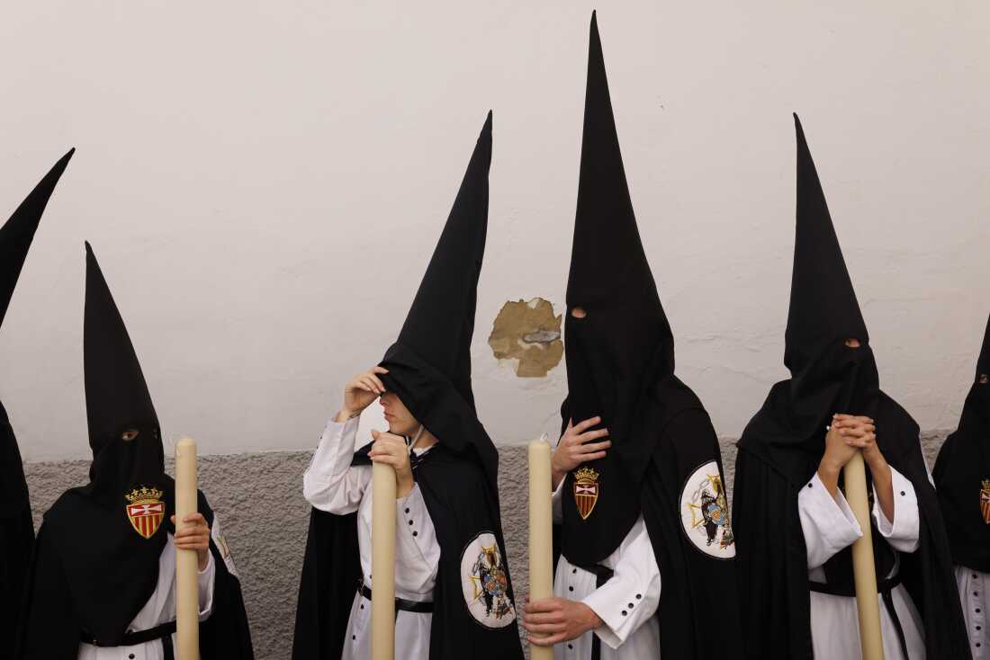  Penitents of Santa Genoveva brotherhood wait before taking part in a procession during Holy Week (Semana Santa) observances on March 30, 2026 in Seville, Spain.