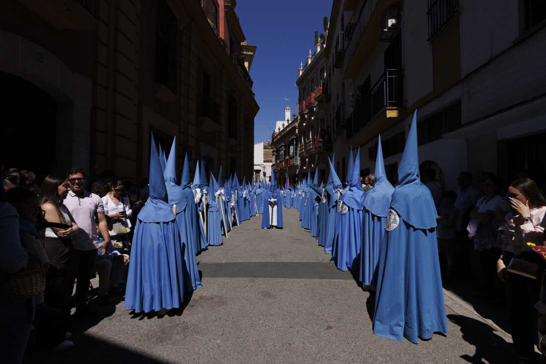 Penitents of San Esteban brotherhood take part in a procession during Holy Week (Semana Santa) observances