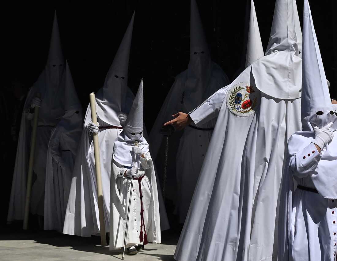 Penitents from the La Paz brotherhood parade in the Palm Sunday procession in Seville on March 29, 2026. 