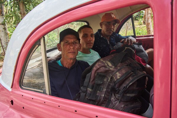 Pardoned prisoners sit in a taxi to return home after leaving La Lima penitentiary in Guanabacoa, Havana, Cuba, Friday, April 3, 2026. (AP Photo/Ramon Espinosa)