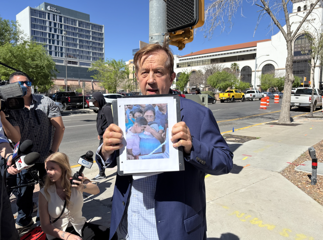 Attorney Randall Kallinen holds a photo of the burial of Victor Manuel Diaz, a Nicaraguan man who died while in detention at Camp East Montana.