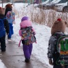 Students walk from a bus at a St. Paul School District elementary school in St. Paul, Minnesota, U.S., March 18, 2026.