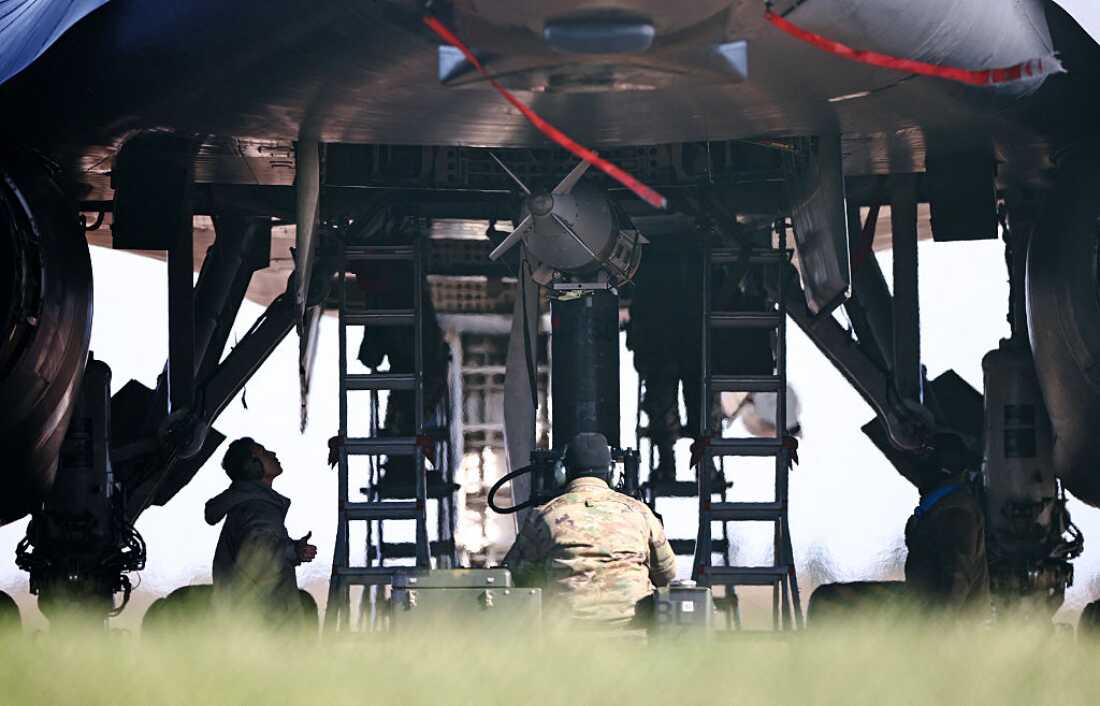 USAF military ground personnel prepare Joint Direct Attack Munitions (JDAM) for a US Air Force (USAF) B-1 Lancer bomber jet on the tarmac the tarmac at RAF Fairford in south-west England on March 14, 2026.