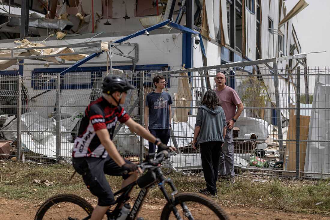People look at the damage at a factory that got hit by a missile in Petah Tikva, east of Tel Aviv, on April 3, 2026.