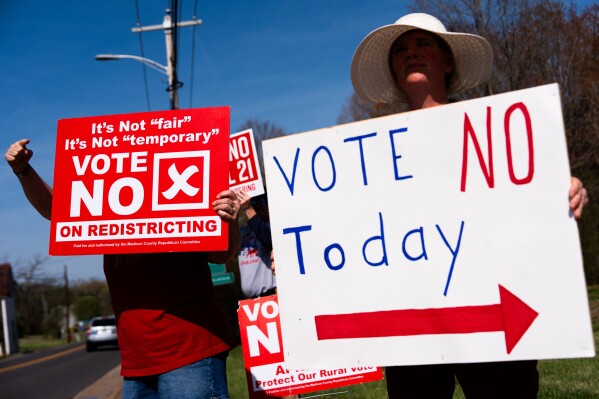 Kasey Griffin, right, and other members of the Madison County Republican Committee wave signs opposing the Virginia redistricting referendum at passing cars, during the early voting period, Friday, April 3, 2026, in Madison, Va. (AP Photo/Julia Demaree Nikhinson)
