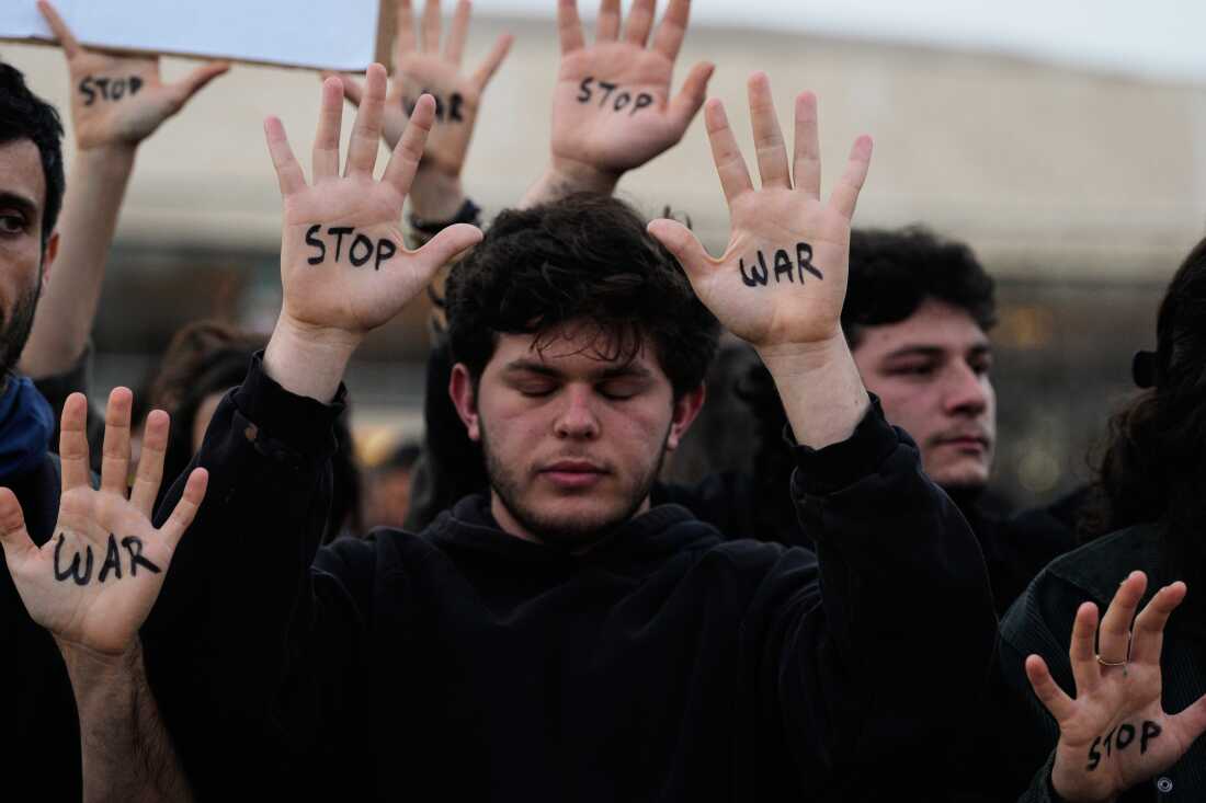 People raise their hands during a protest calling for an end to the war in Tel Aviv, Israel, Saturday, April 4, 2026.