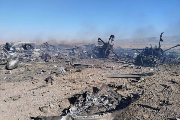 In this image provided by Sepahnews, the Iranian Revolutionary Guard's official website, wreckage is shown at what Iran's state TV claimed was the site of a downed American transport plane and two helicopters involved in a rescue operation, in Isfahan province, Iran, April, 2026. (Sepahnews via AP)