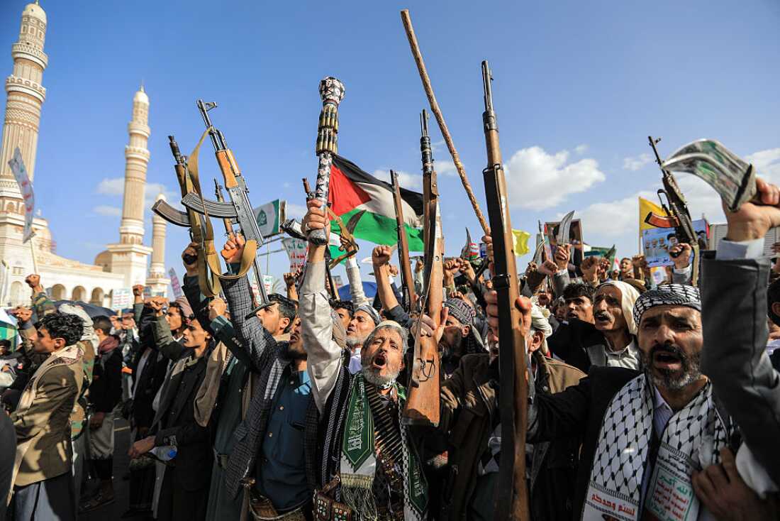 Supporters of the Iran-backed Houthi movement brandish their weapons as they rally in solidarity with Iran and Lebanon amid the US-Israeli war with Iran, in the capital Sanaa on April 3, 2026.