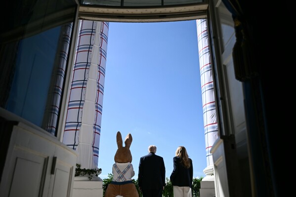 President Donald Trump and first lady Melania Trump participate in the White House Easter Egg Roll on the South Lawn of the White House, Monday, April 6, 2026, in Washington. (Brendan Smialowski/Pool via AP)