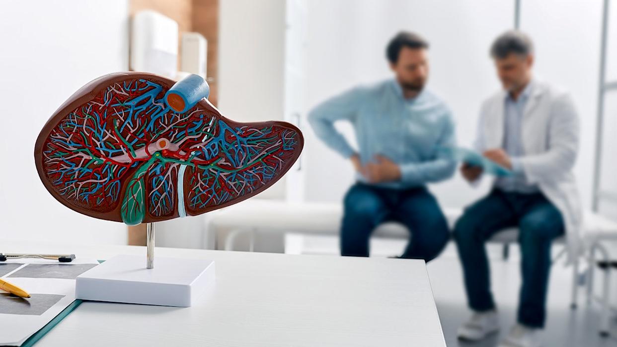 liver diagram with doctor and patient in background