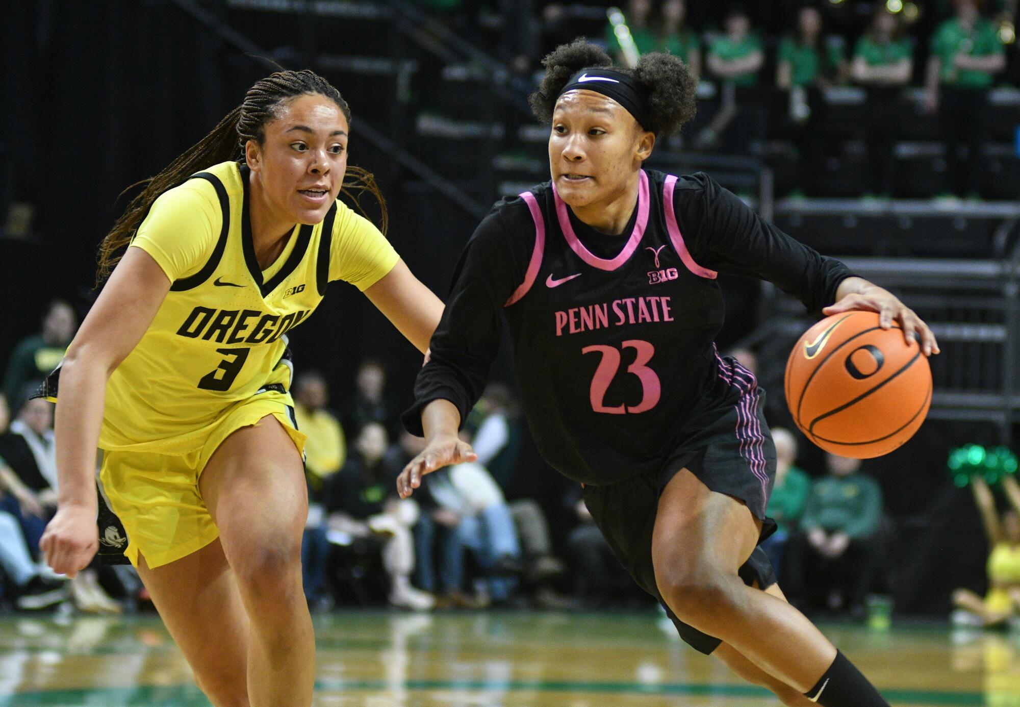 Penn State guard Kiyomi McMiller dribbles in front of Oregon guard Sofia Bell on Jan. 24.