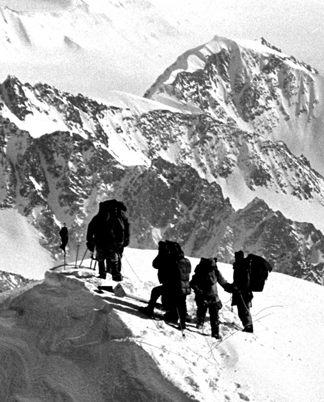 Robert F. Kennedy, left, stands atop Mt. Kennedy after placing a black flag in memorial to his late brother, President John F. Kennedy, next to, from left, Jim Whittaker, William Allard, and George Senner, March 24, 1965, in Yukon, Canada.