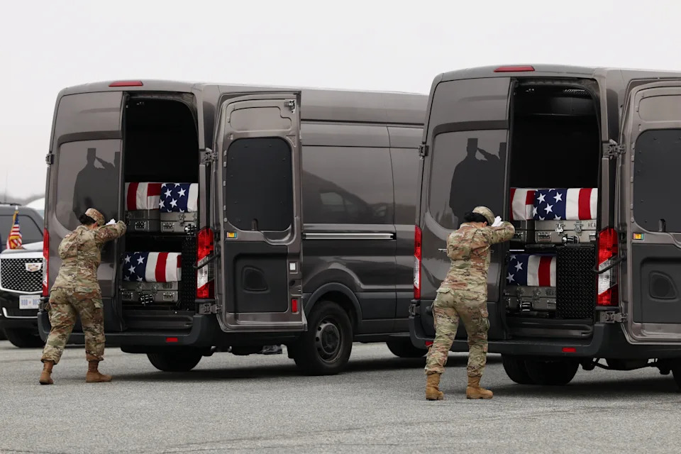 Two members of the military shut the rear doors of two vans containing transfer cases during a dignified transfer of the remains of six U.S. Army service members who were killed in Kuwait, at Dover Air Force Base in Dover, Delaware, on March 7.