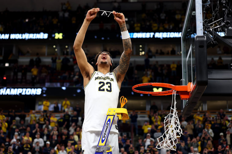 Yaxel Lendeborg of the Michigan Wolverines cuts down the net after a game against the Tennessee Volunteers on March 29, 2026.