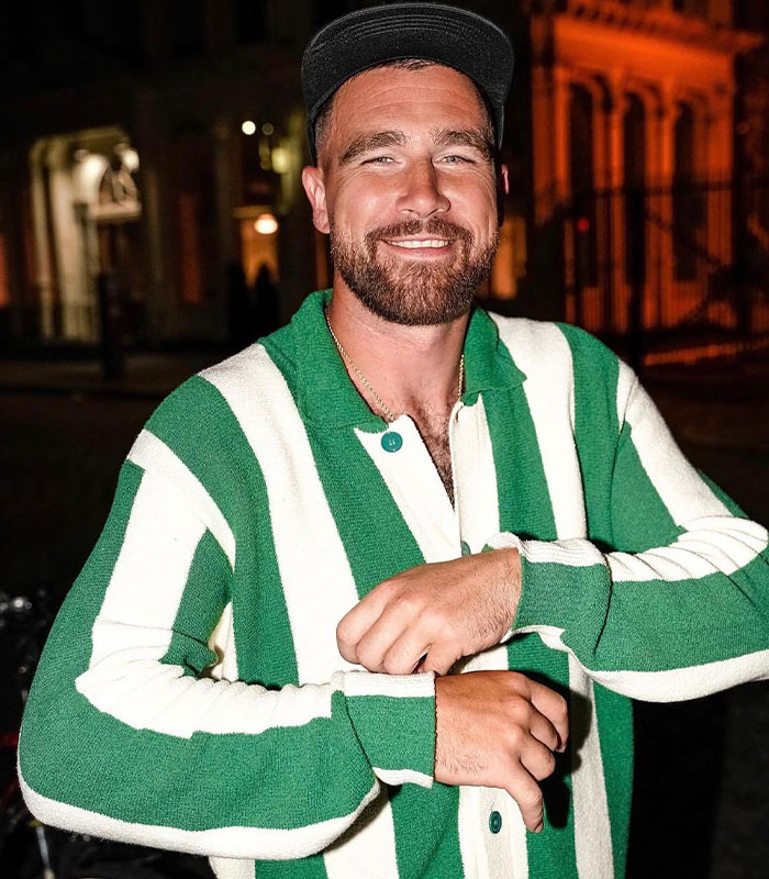 Man in green and white striped sweater and black cap smiling outdoors, related to NASA’s reply to Travis Kelce’s tweet.