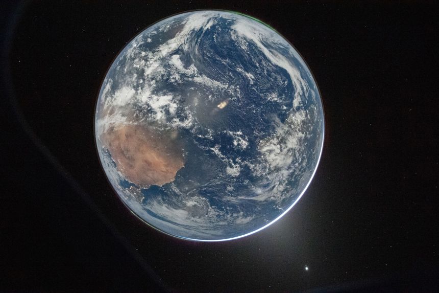 One of the first photos released from the mission shows Earth from the Orion spacecraft’s window, after completing the translunar injection burn on April 2. Two auroras can be seen at the top right and bottom left, and zodiacal light (bottom right) is visible as the Earth eclipses the Sun.