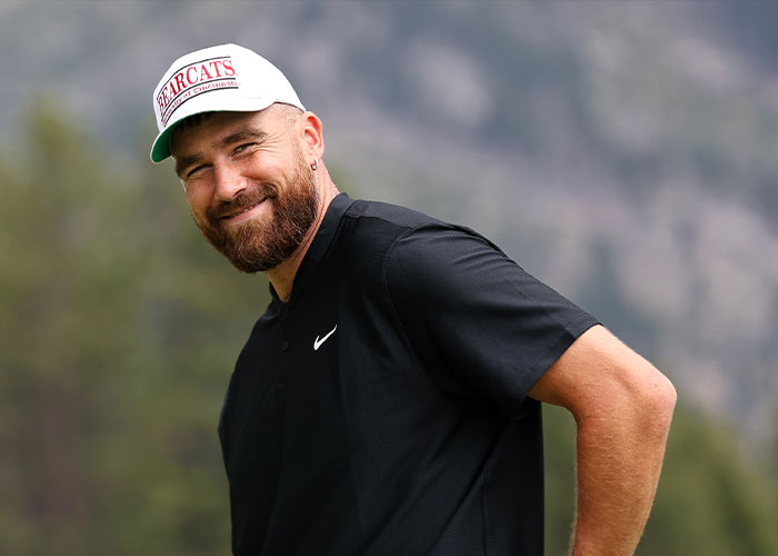 Smiling man wearing a Bearcats cap and black Nike shirt outdoors with blurred natural background, related to NASA reply tweet discussion.