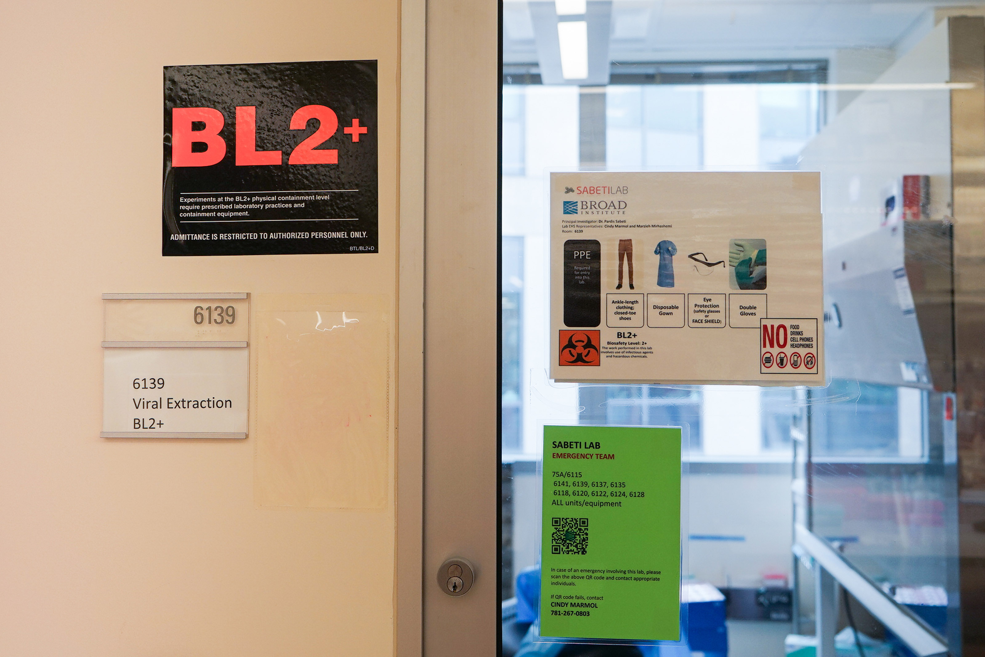 A door leading into a lab with a label on the wall next to it that reads, "6139, Viral Extraction, BL2+"