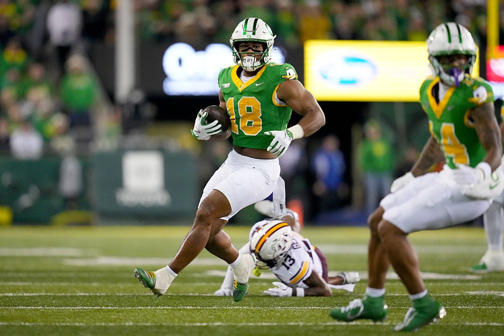 EUGENE, OREGON - NOVEMBER 14: Kenyon Sadiq #18 of the Oregon Ducks runs with the ball past Mike Gerald #13 of the Minnesota Golden Gophers during the second half at Autzen Stadium on November 14, 2025 in Eugene, Oregon. (Photo by Soobum Im/Getty Images)