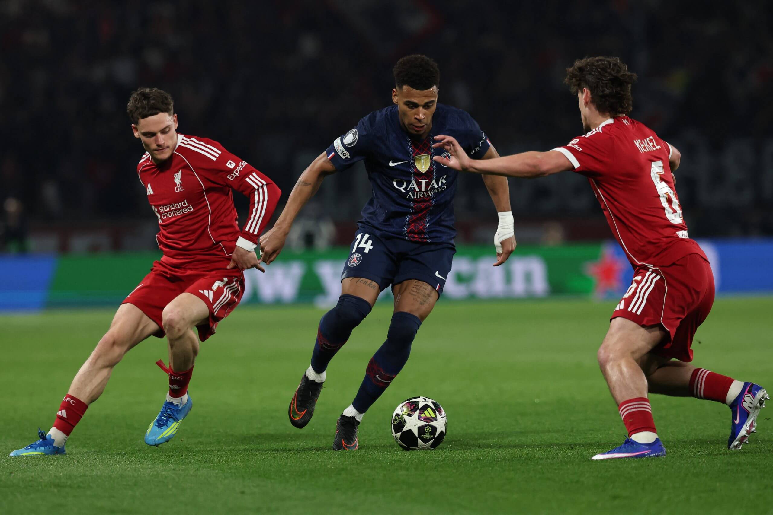 Paris Saint-Germain's Desire Doue takes on Liverpool's Florian Wirtz and Milos Kerkez