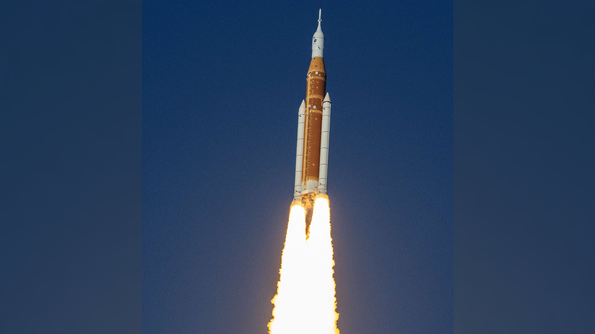a rocket launches into a blue sky