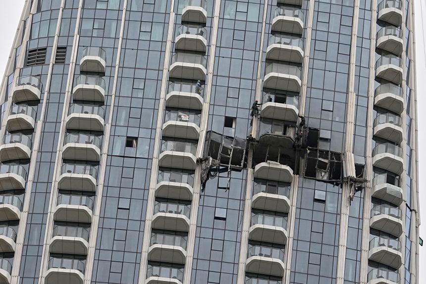 Workers inspect damage caused by a drone strike overnight at a hotel in Dubai, United Arab Emirates, on March 12, 2026.