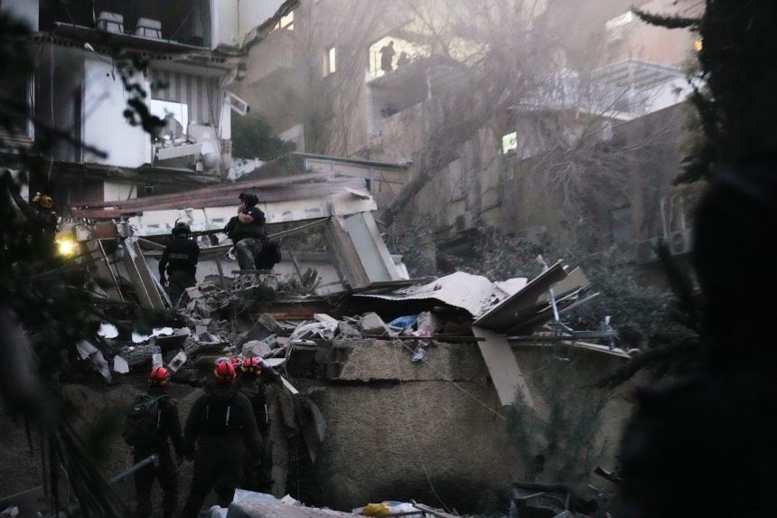 Israeli security forces and rescue teams work amid the rubble of a residential building struck by an Iranian missile in Haifa, Israel, on April 5.