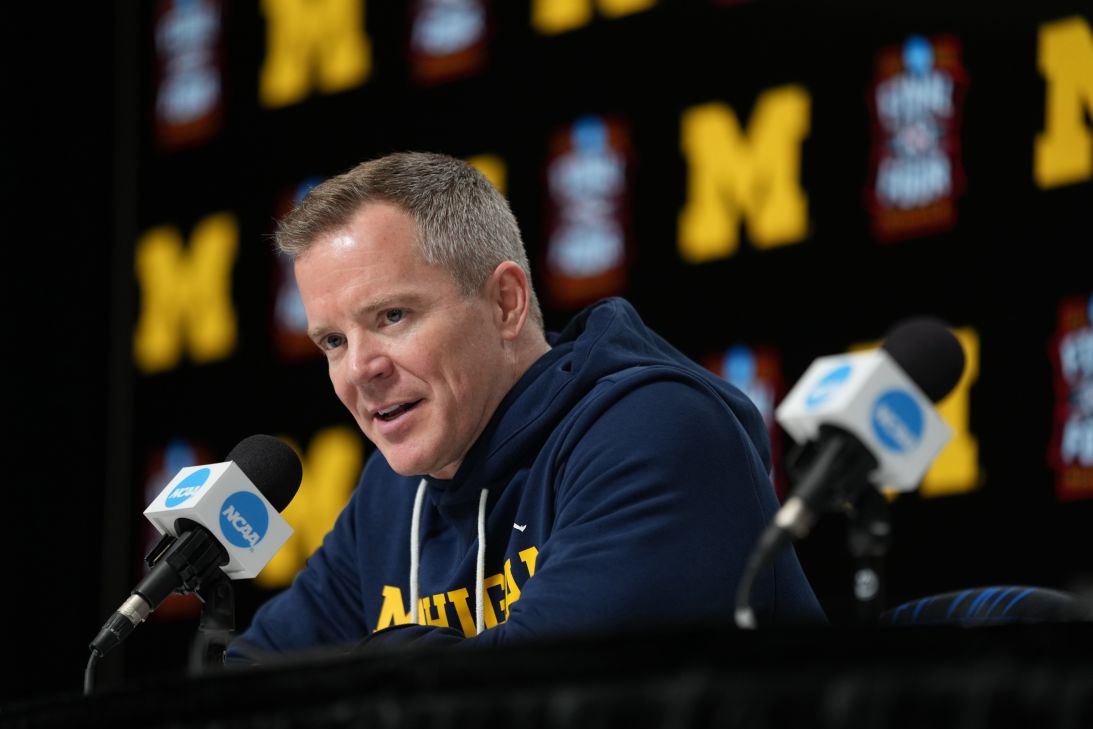 Michigan head coach Dusty May speaks during a news conference ahead of a national semifinal NCAA college basketball tournament game against Arizona at the Final Four.