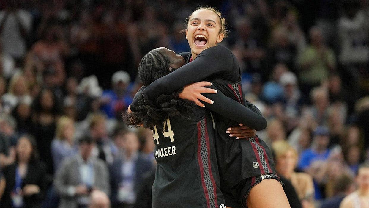 South Carolina guards Tessa Johnson and Agot Makeer celebrating on basketball court