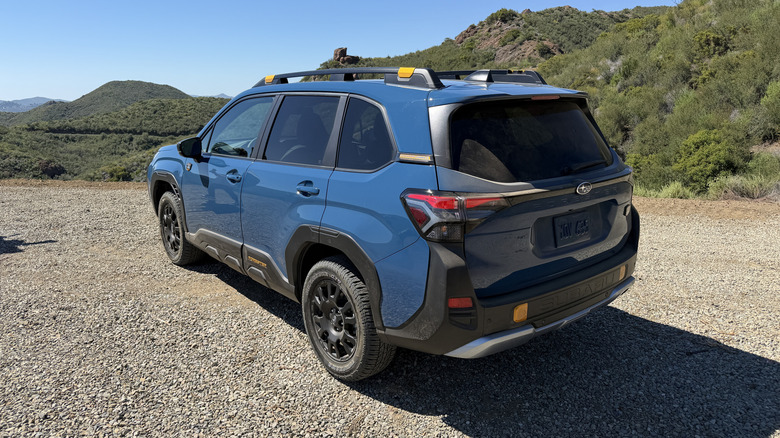Rear 3/4 view of a blue Subaru Forester Wilderness Hybrid