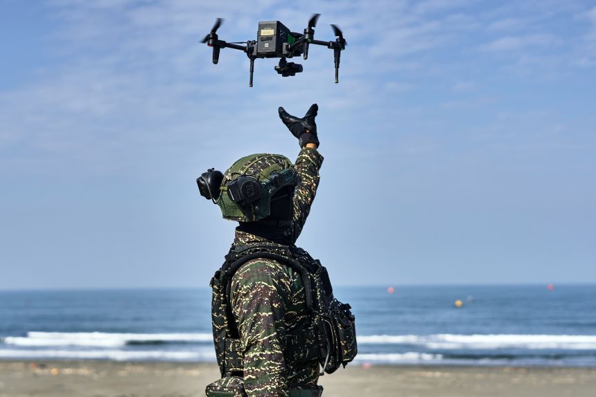 A solider releases a drone during a military exercise outside a naval base in Kaohsiung, Taiwan, on January 29, 2026.