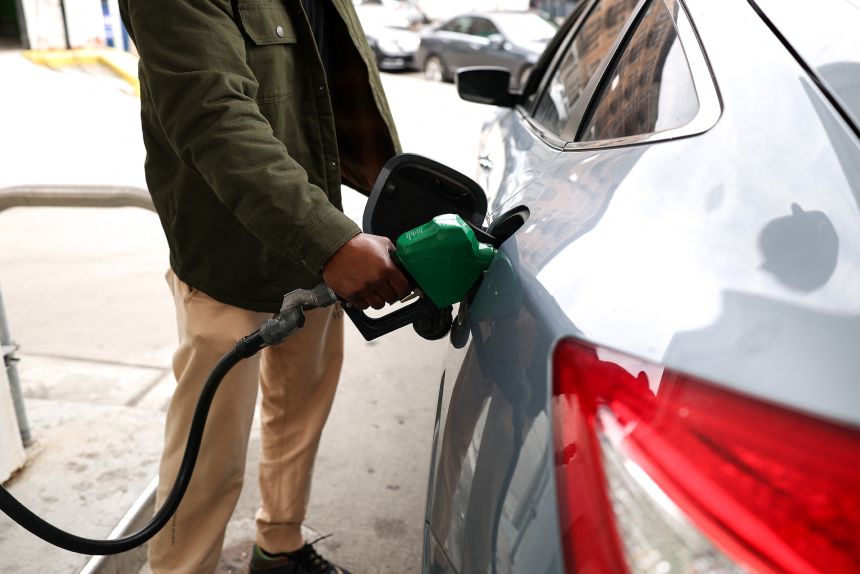 A person fills up their vehicle's tank at a gas station in New York City on March 31. The average price per gallon hit $4 this week for the first time since 2022.